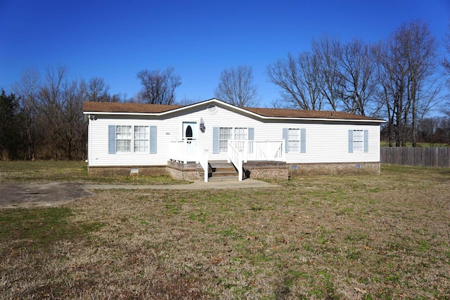 manufactured / mobile home with crawl space, a front yard, and fence