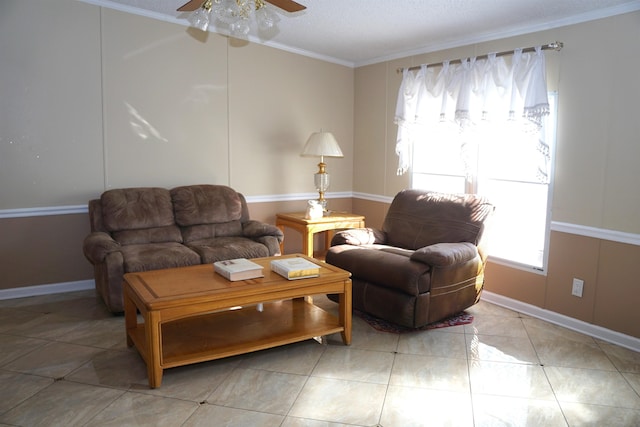 living area with baseboards, ceiling fan, a textured ceiling, crown molding, and light tile patterned flooring