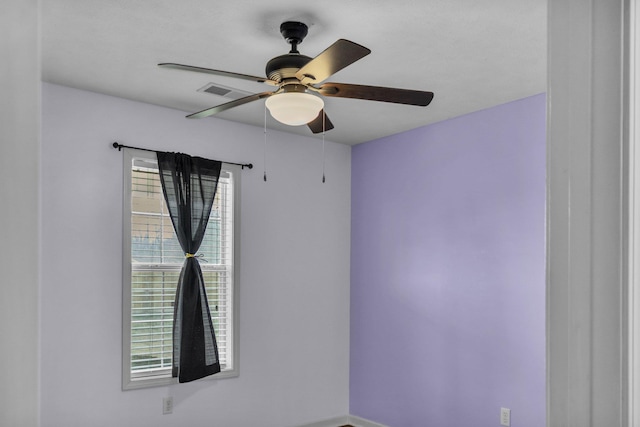 empty room with visible vents and ceiling fan