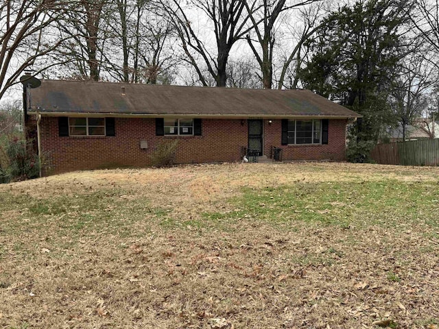 single story home featuring fence, a front lawn, and brick siding