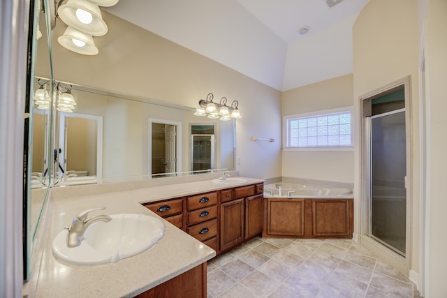 bathroom featuring double vanity, a stall shower, and a sink