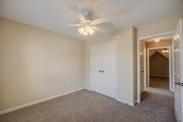 unfurnished bedroom with carpet floors, a closet, baseboards, and a ceiling fan