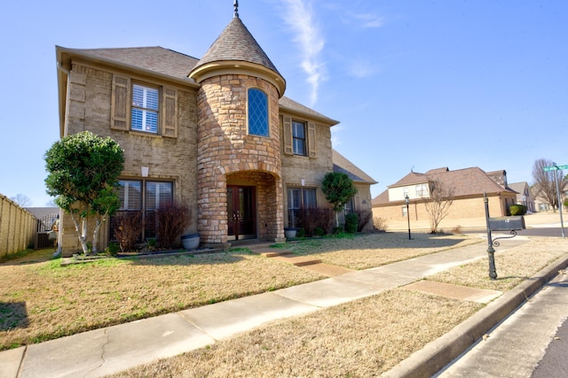 view of front of home featuring a front yard and stone siding