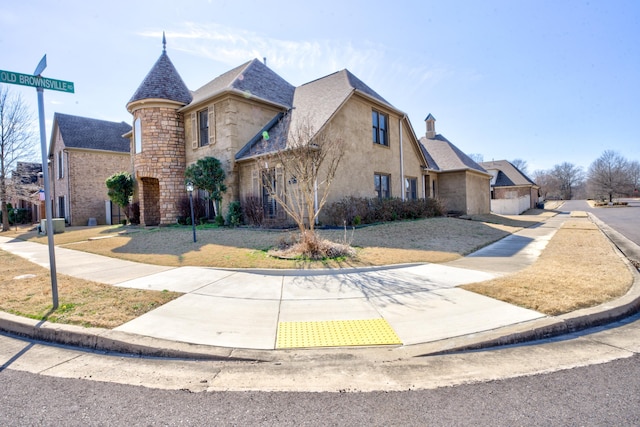 view of front of home with stone siding and stucco siding