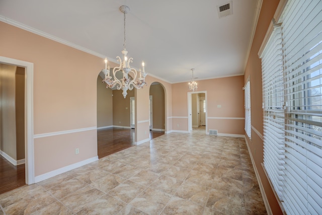 unfurnished room with a chandelier, baseboards, visible vents, and crown molding