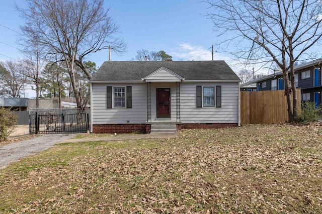bungalow-style home with crawl space, a shingled roof, and fence