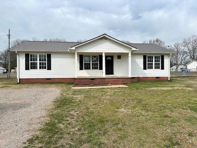 view of front of house featuring crawl space, metal roof, and a front lawn