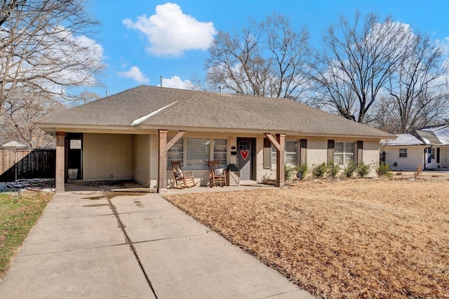 single story home with roof with shingles, fence, concrete driveway, and brick siding