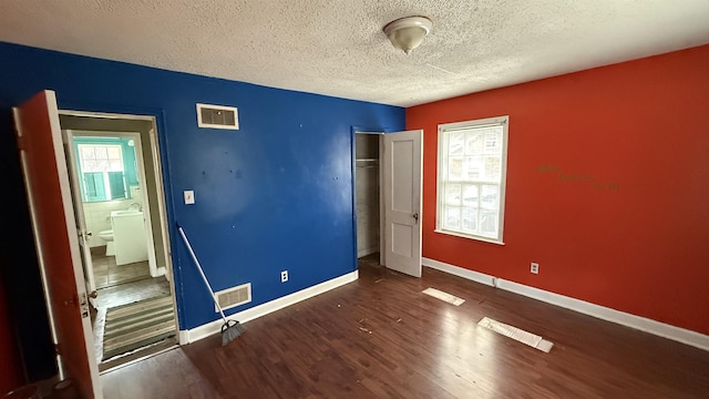 unfurnished bedroom with baseboards, a closet, visible vents, and wood finished floors