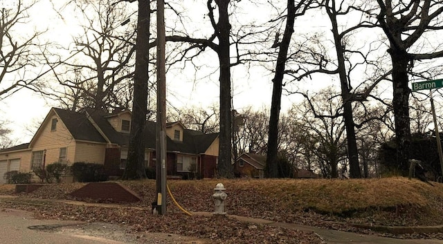 view of side of home with a residential view and brick siding