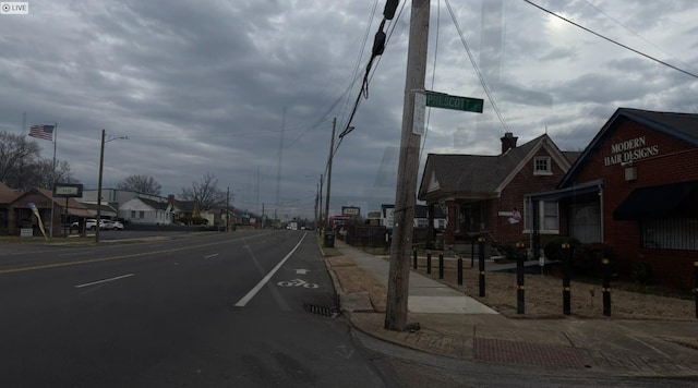 view of street with street lighting, sidewalks, and a residential view