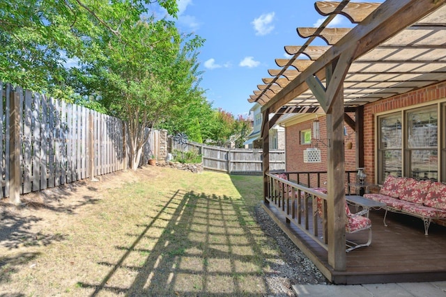 view of yard featuring a fenced backyard, a deck, and a pergola