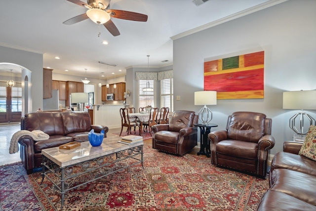 living room with recessed lighting, ceiling fan, arched walkways, and ornamental molding