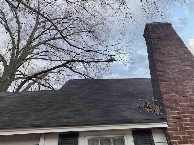 details with roof with shingles and a chimney