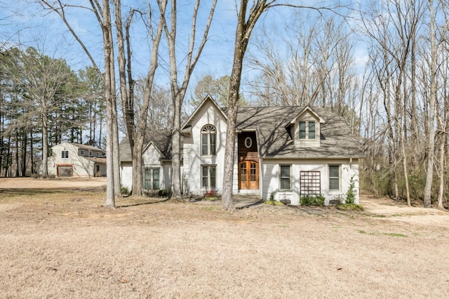 view of front facade featuring driveway and roof with shingles