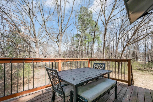 wooden terrace featuring outdoor dining area