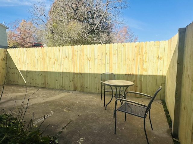 view of patio featuring fence