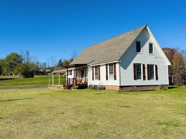 back of property with crawl space, a lawn, and roof with shingles