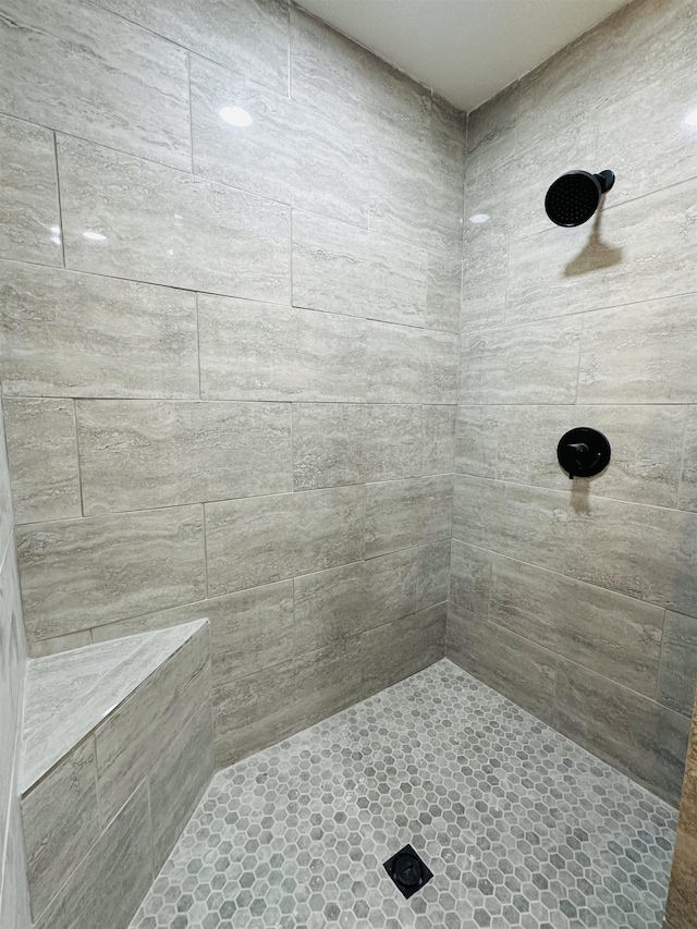 full bathroom with tiled shower