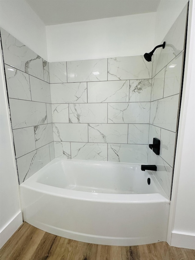 full bathroom with  shower combination, baseboards, and wood finished floors