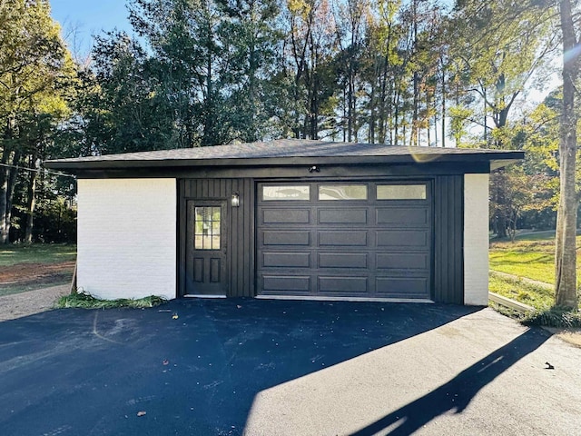 detached garage featuring aphalt driveway