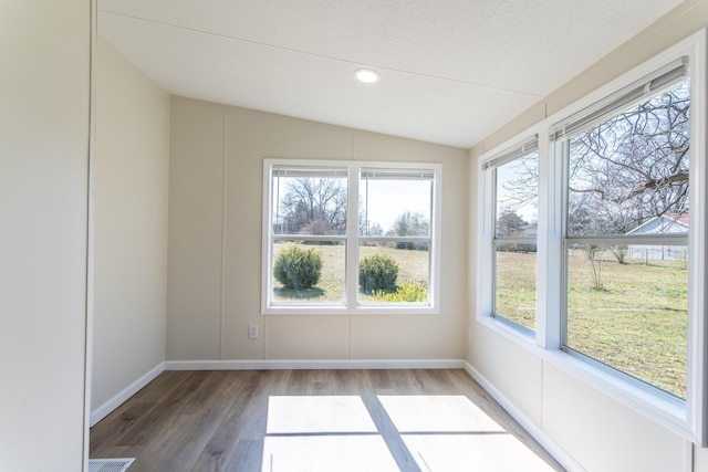 unfurnished sunroom featuring lofted ceiling