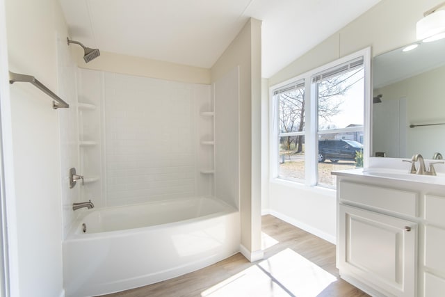 full bathroom with shower / bathing tub combination, vanity, baseboards, and wood finished floors