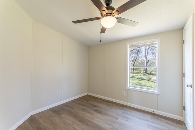 unfurnished room with ceiling fan and light wood-style floors