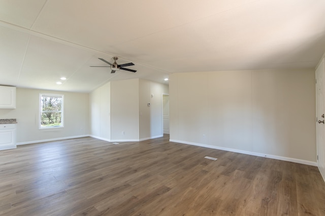 unfurnished living room featuring wood finished floors, a ceiling fan, and baseboards