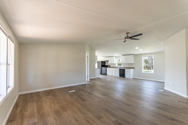 unfurnished living room featuring ceiling fan, dark wood-style flooring, and baseboards