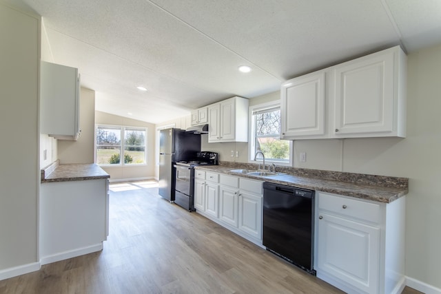 kitchen with a wealth of natural light, black dishwasher, a sink, and electric range