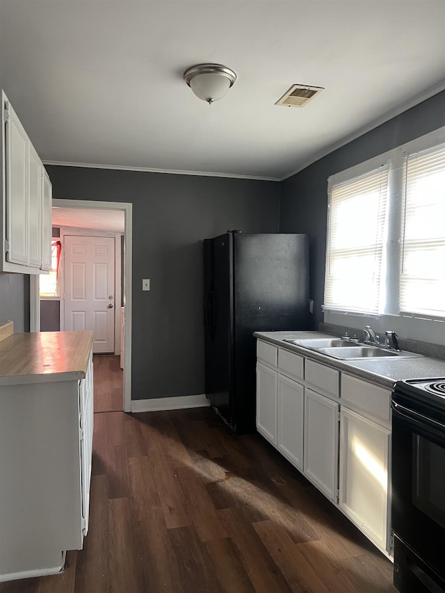 kitchen featuring black appliances, dark wood-style flooring, visible vents, and white cabinetry