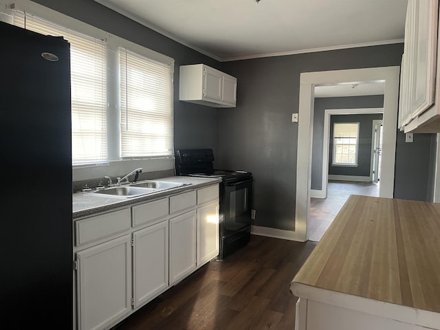 kitchen featuring ornamental molding, plenty of natural light, a sink, and black appliances