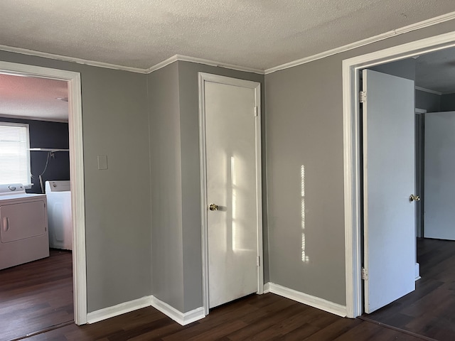 unfurnished bedroom featuring ornamental molding, washing machine and clothes dryer, and dark wood finished floors