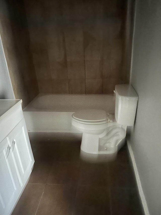 bathroom featuring a bathing tub, toilet, and tile patterned floors