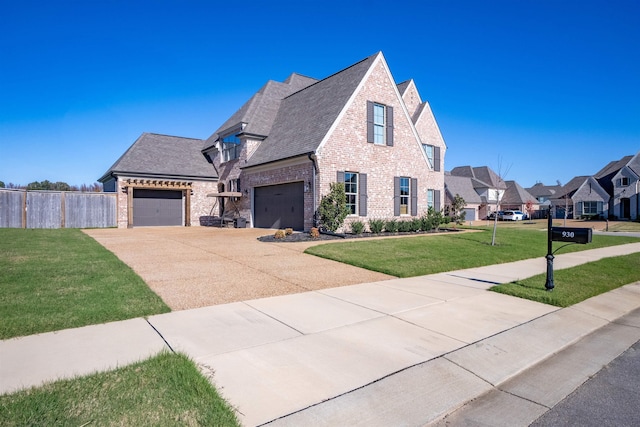 view of front of property with brick siding, fence, driveway, roof with shingles, and a front yard