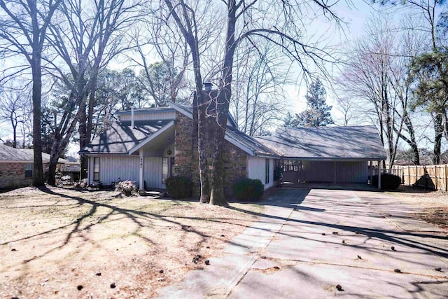 view of front of home with driveway and fence