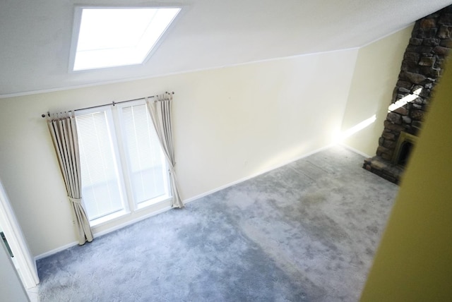 bonus room featuring carpet floors and vaulted ceiling with skylight