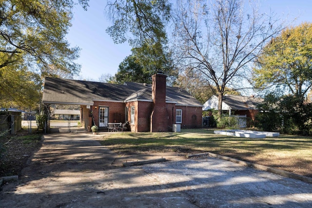 view of property exterior with a yard, cooling unit, brick siding, and fence