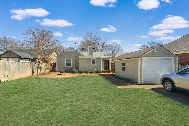 ranch-style home with a garage, fence, a chimney, and a front lawn