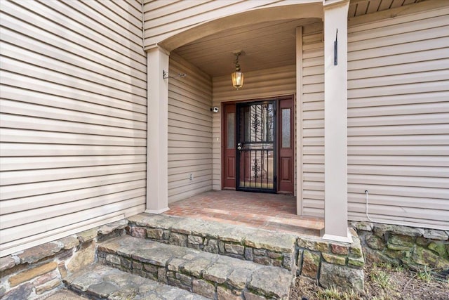 view of exterior entry featuring a porch