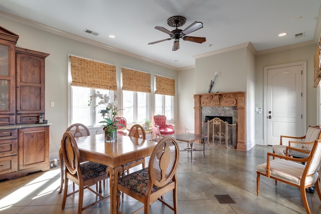 dining space featuring ornamental molding, a premium fireplace, visible vents, and recessed lighting