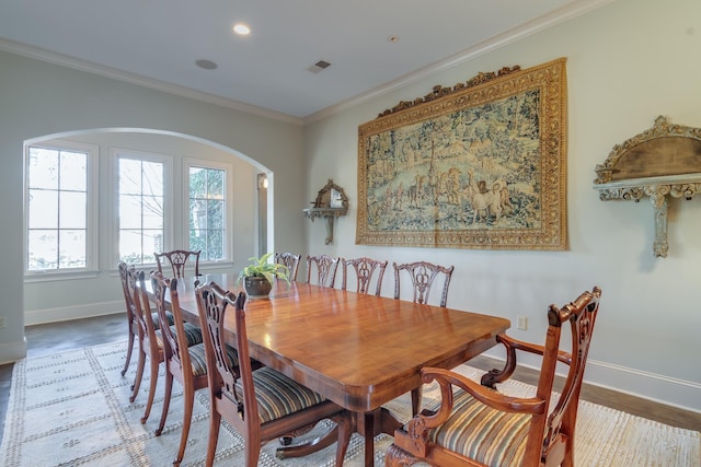 dining room with arched walkways, recessed lighting, visible vents, baseboards, and crown molding