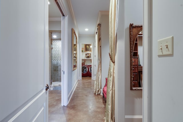 corridor with baseboards, independent washer and dryer, finished concrete floors, crown molding, and recessed lighting