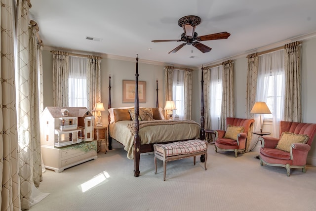 bedroom featuring ceiling fan, carpet flooring, visible vents, and crown molding