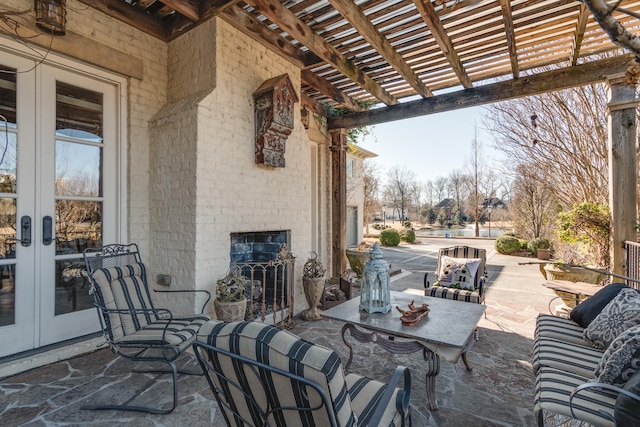 view of patio with french doors, outdoor dining space, and a pergola