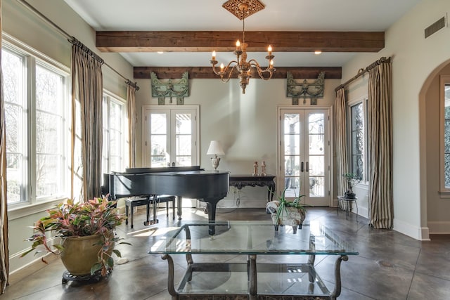 living area with arched walkways, visible vents, baseboards, french doors, and plenty of natural light