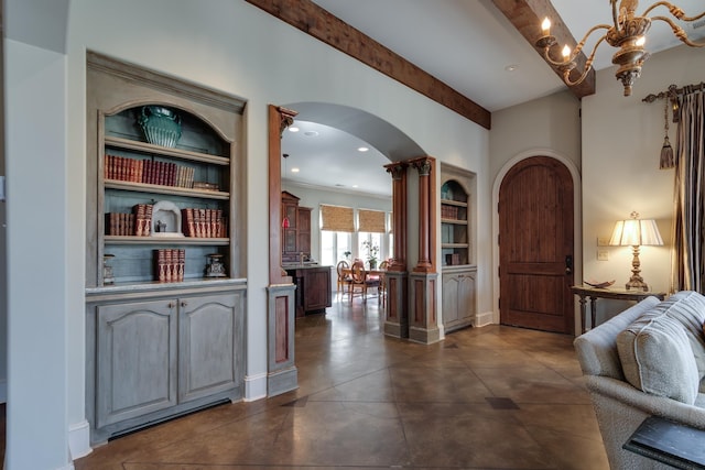 corridor featuring a notable chandelier, arched walkways, beam ceiling, and recessed lighting