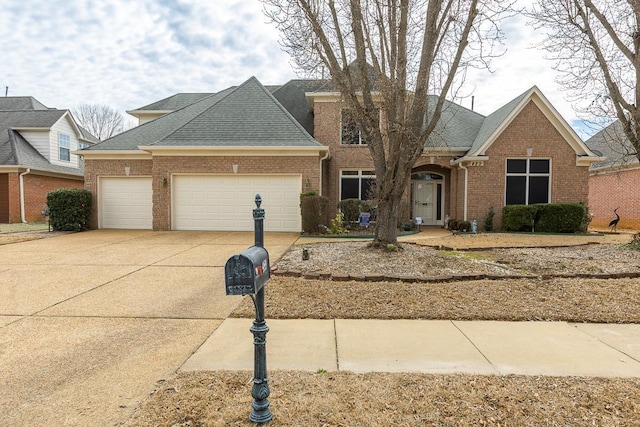 view of front of property featuring a garage, concrete driveway, brick siding, and roof with shingles