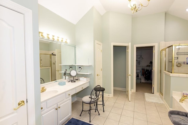 full bathroom featuring a spacious closet, vaulted ceiling, a shower stall, vanity, and tile patterned floors